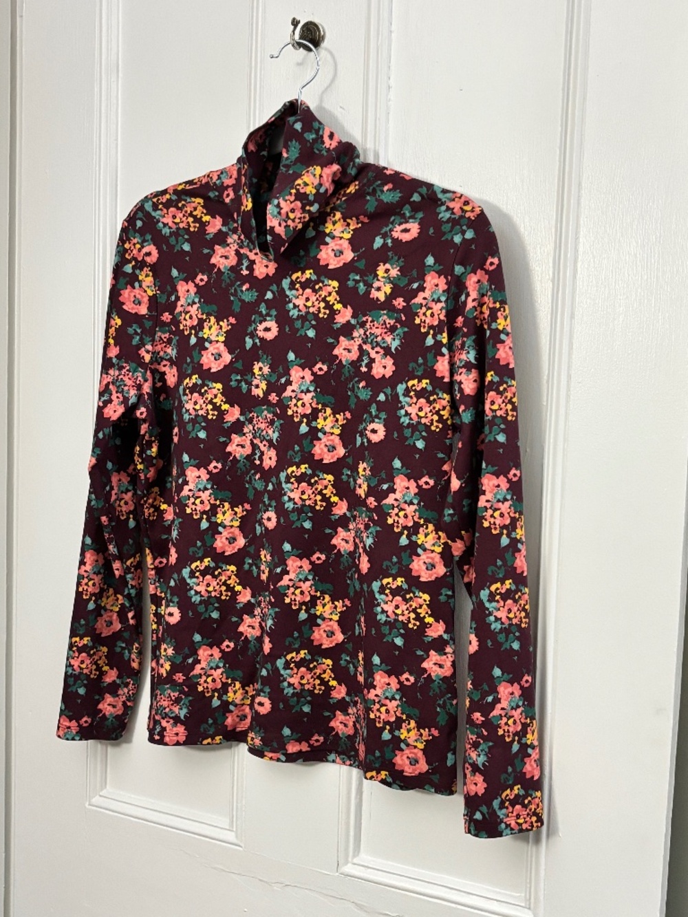 L.L.Bean women's turtleneck top floral print on a burgundy base.